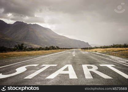 Start new way right here. Conceptual image with word start on asphalt road