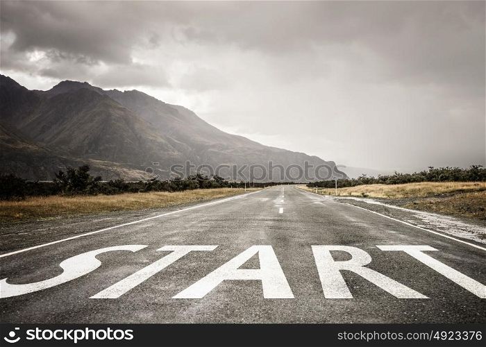 Start new way right here. Conceptual image with word start on asphalt road