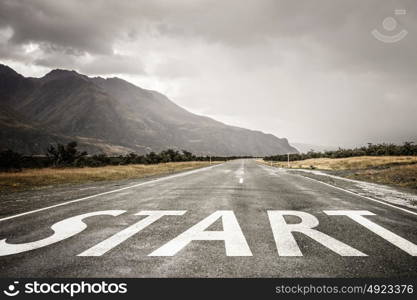 Start new way right here. Conceptual image with word start on asphalt road