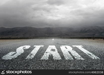 Start new way right here. Conceptual image with word start on asphalt road