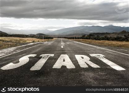 Start new way right here. Conceptual image with word start on asphalt road