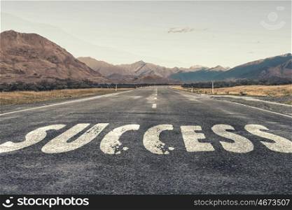 Start new way right here. Conceptual image with word success on asphalt road