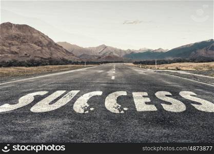Start new way right here. Conceptual image with word success on asphalt road