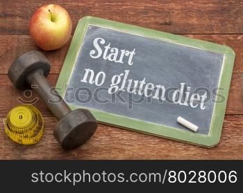 start no gluten diet advice - slate blackboard sign against weathered red painted barn wood with a dumbbell, apple and tape measure