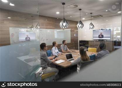 start up business people group attending videoconference call with senior investitior at modern office