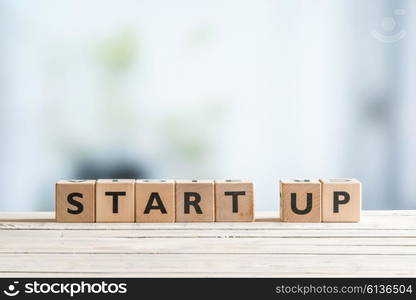 Start up sign on a wooden office desk