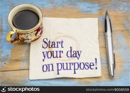 Start your day on purpose! A motivational advice or reminder on a napkin with a cup of coffee