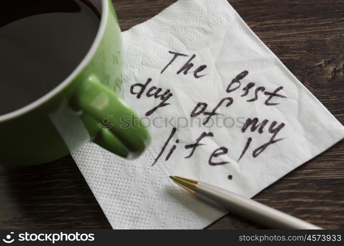 Start your day with positivity. Best day ever message written on napkin and cup of coffee