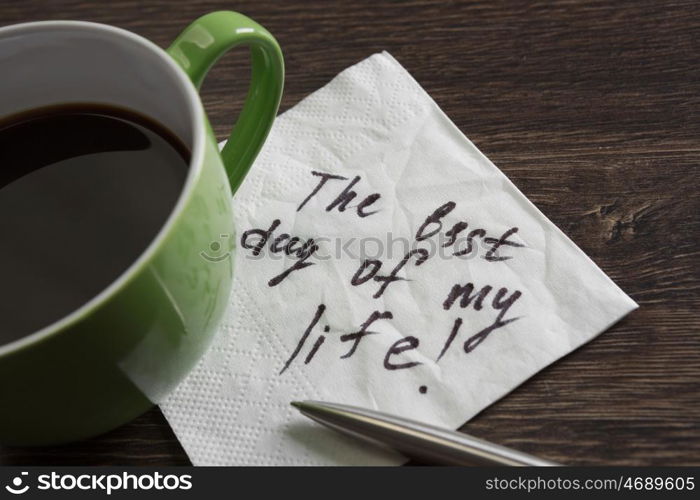 Start your day with positivity. Best day ever message written on napkin and cup of coffee