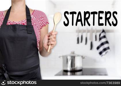 starters cook holding wooden spoon background.. starters cook holding wooden spoon background