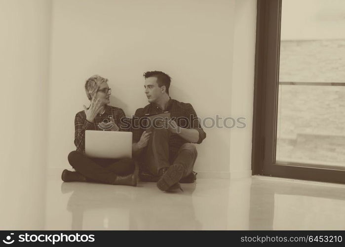 startup business and new mobile technology concept with young couple in modern bright office interior working on laptop and tablet computer on new creative project and brainstorming