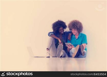 startup business and new mobile technology concept with young multiethnic couple in modern bright office interior working on laptop and tablet computer on new creative project and brainstorming