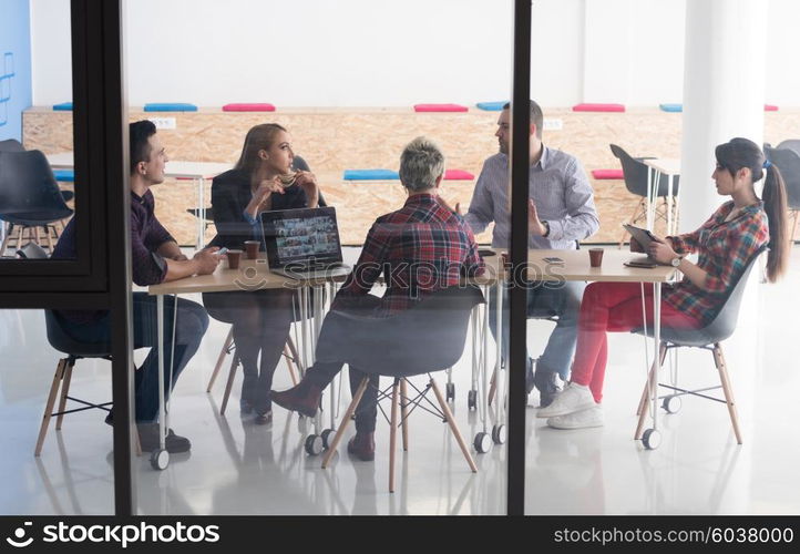 startup business team on meeting in modern bright office interior brainstorming, working on laptop and tablet computer