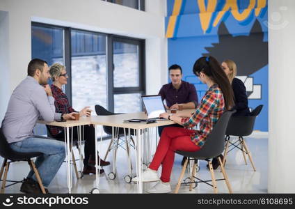 startup business team on meeting in modern bright office interior brainstorming, working on laptop and tablet computer