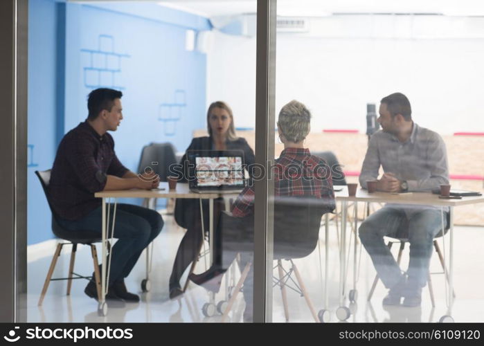 startup business team on meeting in modern bright office interior brainstorming, working on laptop and tablet computer