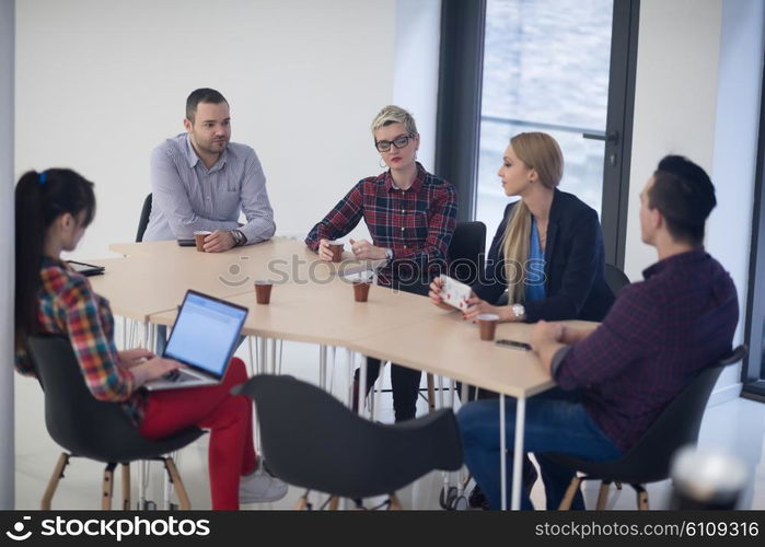 startup business team on meeting in modern bright office interior brainstorming, working on laptop and tablet computer