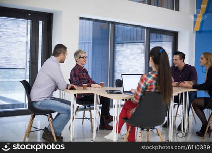 startup business team on meeting in modern bright office interior brainstorming, working on laptop and tablet computer