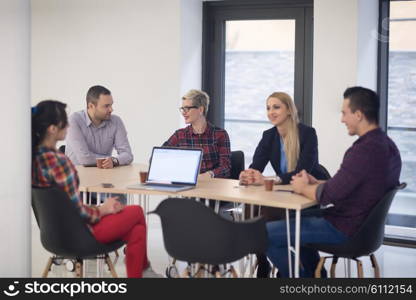 startup business team on meeting in modern bright office interior brainstorming, working on laptop and tablet computer