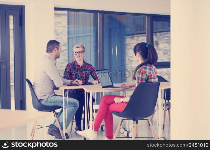 startup business team on meeting in modern bright office interior brainstorming, working on laptop and tablet computer