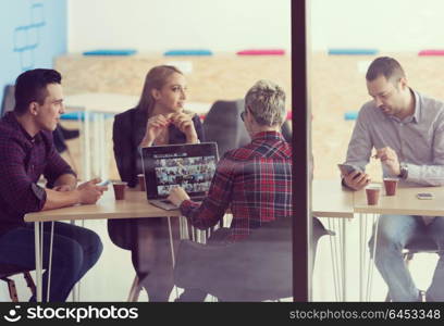 startup business team on meeting in modern bright office interior brainstorming, working on laptop and tablet computer