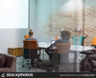 startup Business team using virtual reality headset in night office meeting Developers meeting with virtual reality simulator around table in creative office.