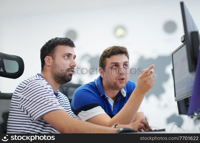 startup business, two male software developers working on computer at new modern open plan office