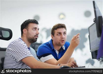 startup business, two male software developers working on computer at new modern open plan office