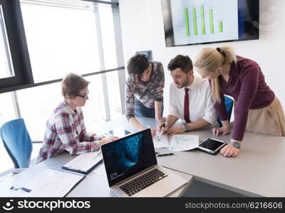 startup business, young creative people group brainstorming on meeting at office interior and using laptop and tablet computer to note ideas plans and projects