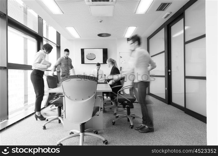 startup business young creative people group entering meeting room with motion blur modern office interior