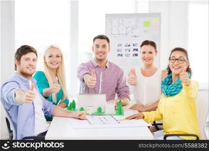startup, education, architecture and office concept - smiling architects with house model and blueprint showing thumbs up