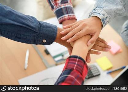 startup man woman joining united hand, business team touching hands together after complete a deal in meeting. unity teamwork partnership corporate concept.