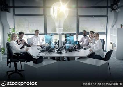 startup, technology and people concept - business team with computers waving hands at office. business team waving hands at office