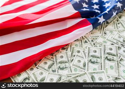 state budget, finance and nationalism concept - close up of american flag and dollar cash money