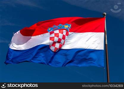State national flag with coat of arms on a background of blue sky. Split Croatia.. Split. National state flag.