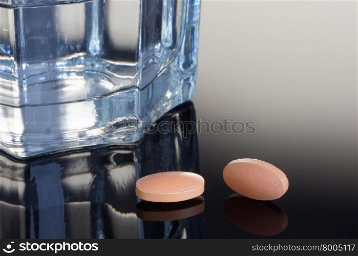 Statin tablets with a glass of water. Health/Medical concept