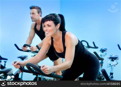 Stationary spinning bicycles fitness girl in a gym sport club