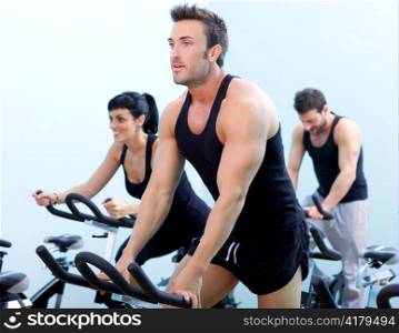 Stationary spinning bicycles fitness man in a gym sport club