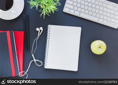 stationery near coffee cup apple table with keyboard