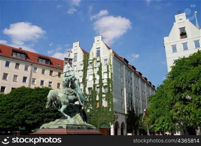 Statue and Berlin architecture with plant climbers