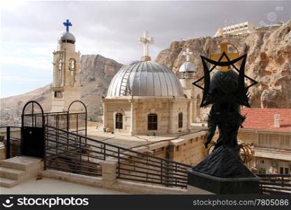 Statue and towers in convent Saint Takla in Maalula, Syria