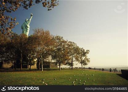 Statue behind trees, Statue Of Liberty, New York City, New York State, USA