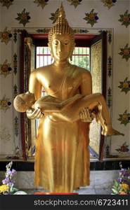Statue Buddha with child in Wat Senassanaram, Ayutthaya, Thailand