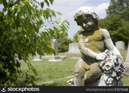 Statue in a graveyard with trees