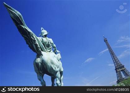 Statue in front of a tower, Eiffel Tower, Paris, France