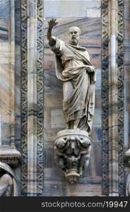 statue in the front of the dome of milan