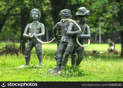 statue of a kid playing in a park