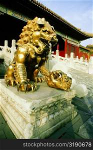 Statue of a lion in front of a building, Forbidden City, Beijing, China