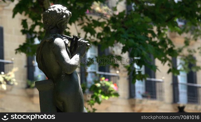 Statue of a person playing a flute
