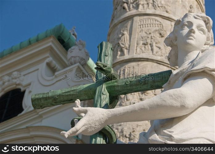 Statue of an Angel with cross and snake with the spiral column i