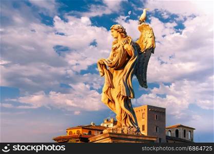 Statue of Angel on Saint Angel Bridge, Rome, Italy. Marble statue of Angel with the Garment and Dice at sunset, one of the ten angels on Saint Angel Bridge, symbols of Christ&rsquo;s Passion, Rome, Italy